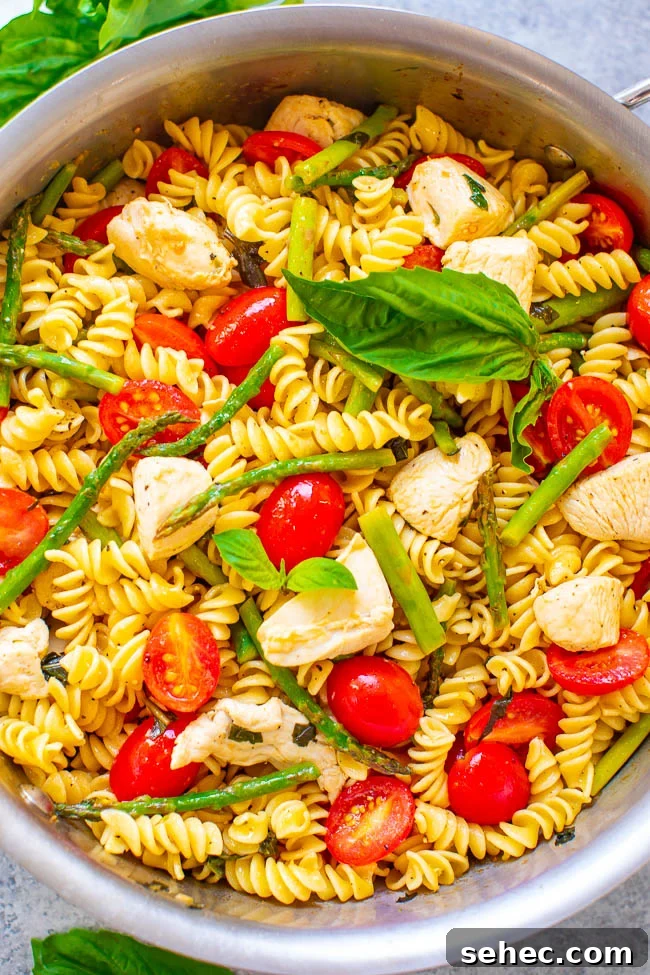 Chicken Asparagus Pasta with Tomatoes 11 A pot of chicken asparagus pasta with tomatoes.
