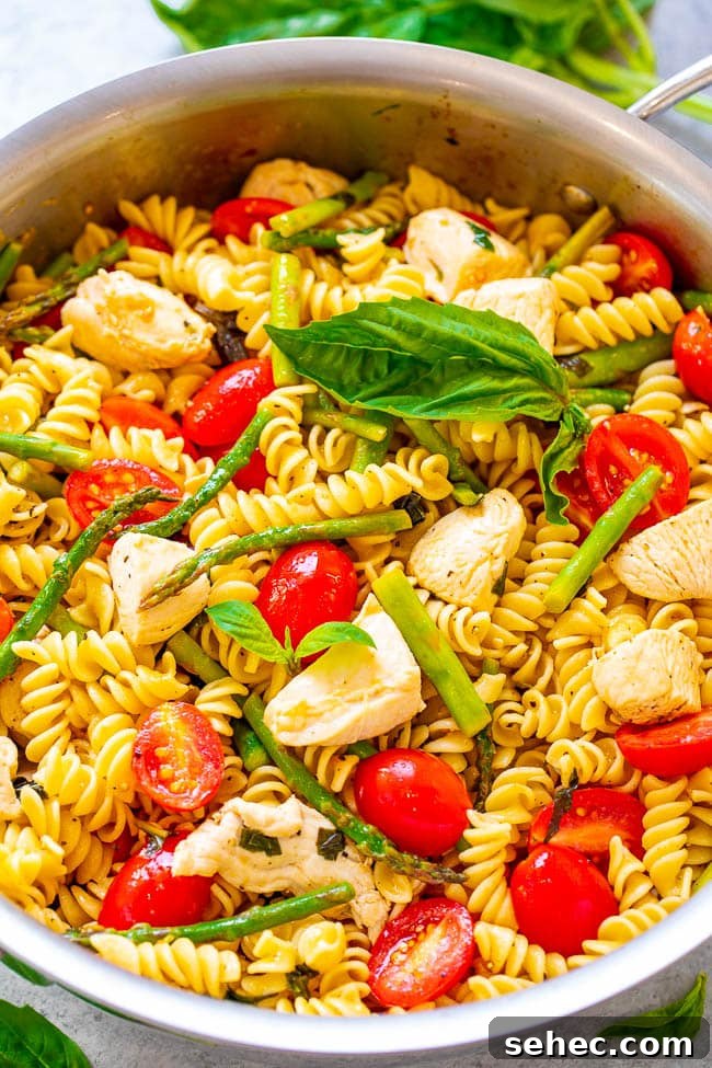 Chicken Asparagus Pasta with Tomatoes 4 Chicken Asparagus Pasta with tomatoes in a pot.