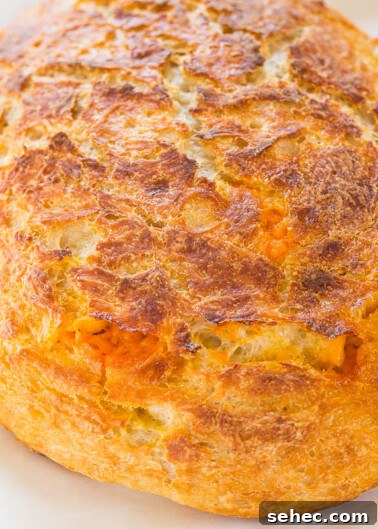 Chicken Asparagus Pasta with Tomatoes 7 A freshly baked loaf of bread with a golden-brown crust.