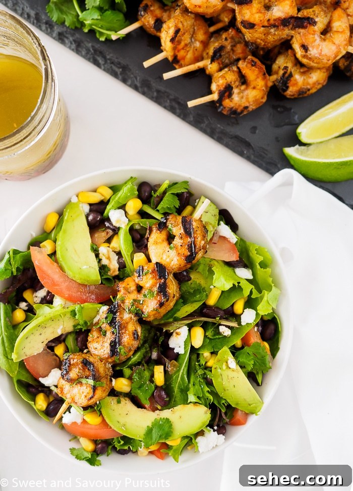 Southwestern Grilled Shrimp Salad with Avocado 3 Southwestern Grilled Shrimp Salad served with extra southwest vinaigrette and lime wedges on the side.