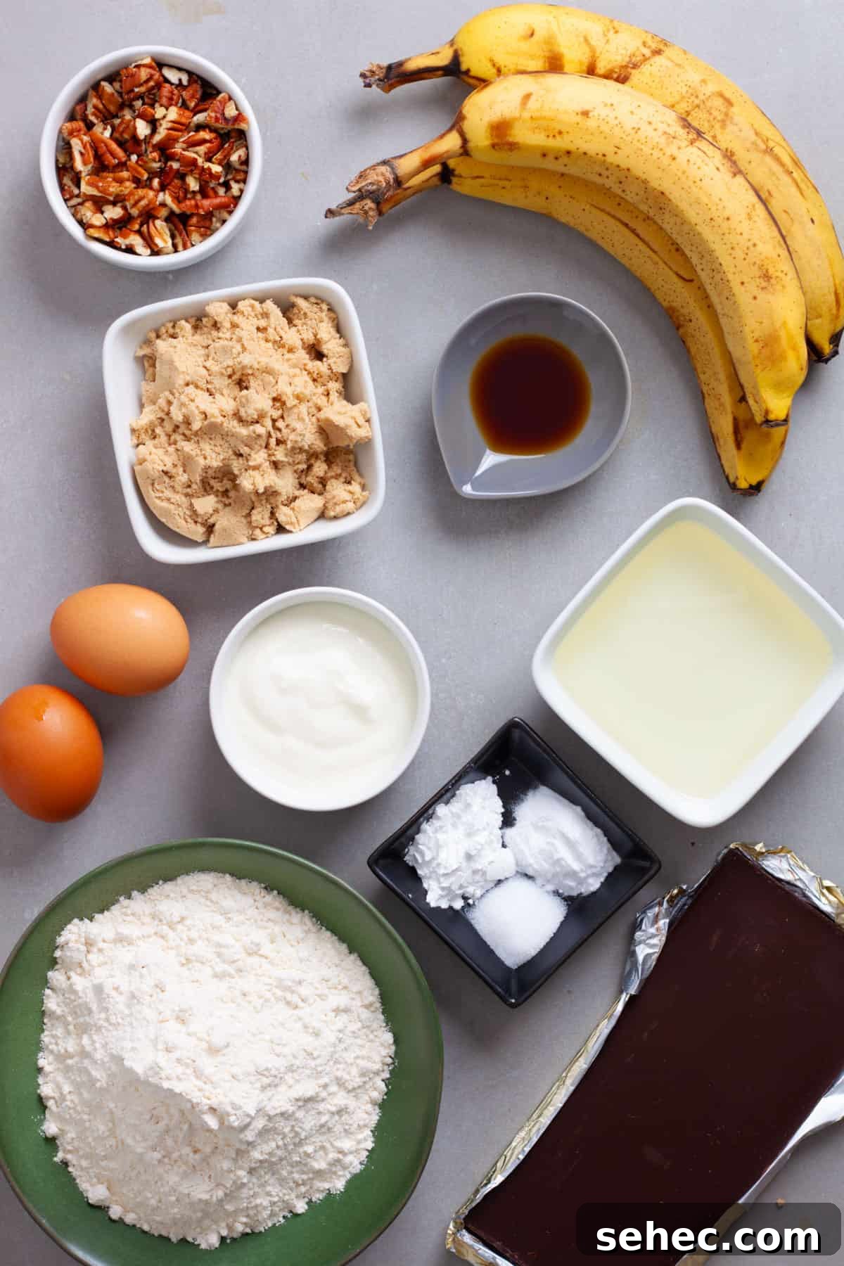 Moist Banana Chocolate Chunk Muffins 3 Ingredients for banana chocolate chunk muffins on a gray table.