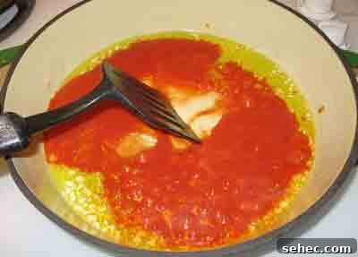 Greek Manestra Orzo in Tomato Sauce 5 Saute the tomato sauce for menestra for a few minutes.