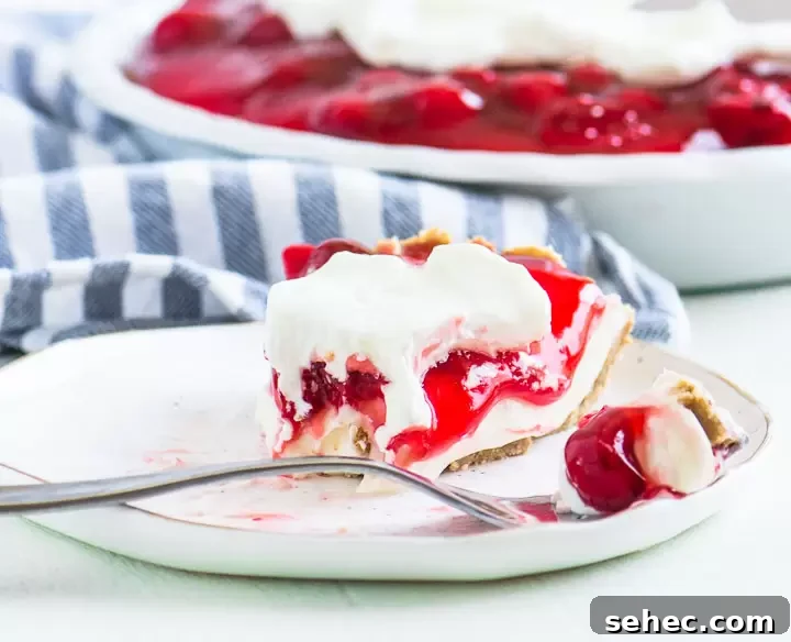 Cherry Cream Pie Recipe with Flaky Crust 2 slice of cherry cream pie on a plate with the rest of the pie behind it