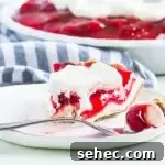 Cherry Cream Pie Recipe with Flaky Crust 7 slice of cherry cream pie on a plate with the rest of the pie behind it