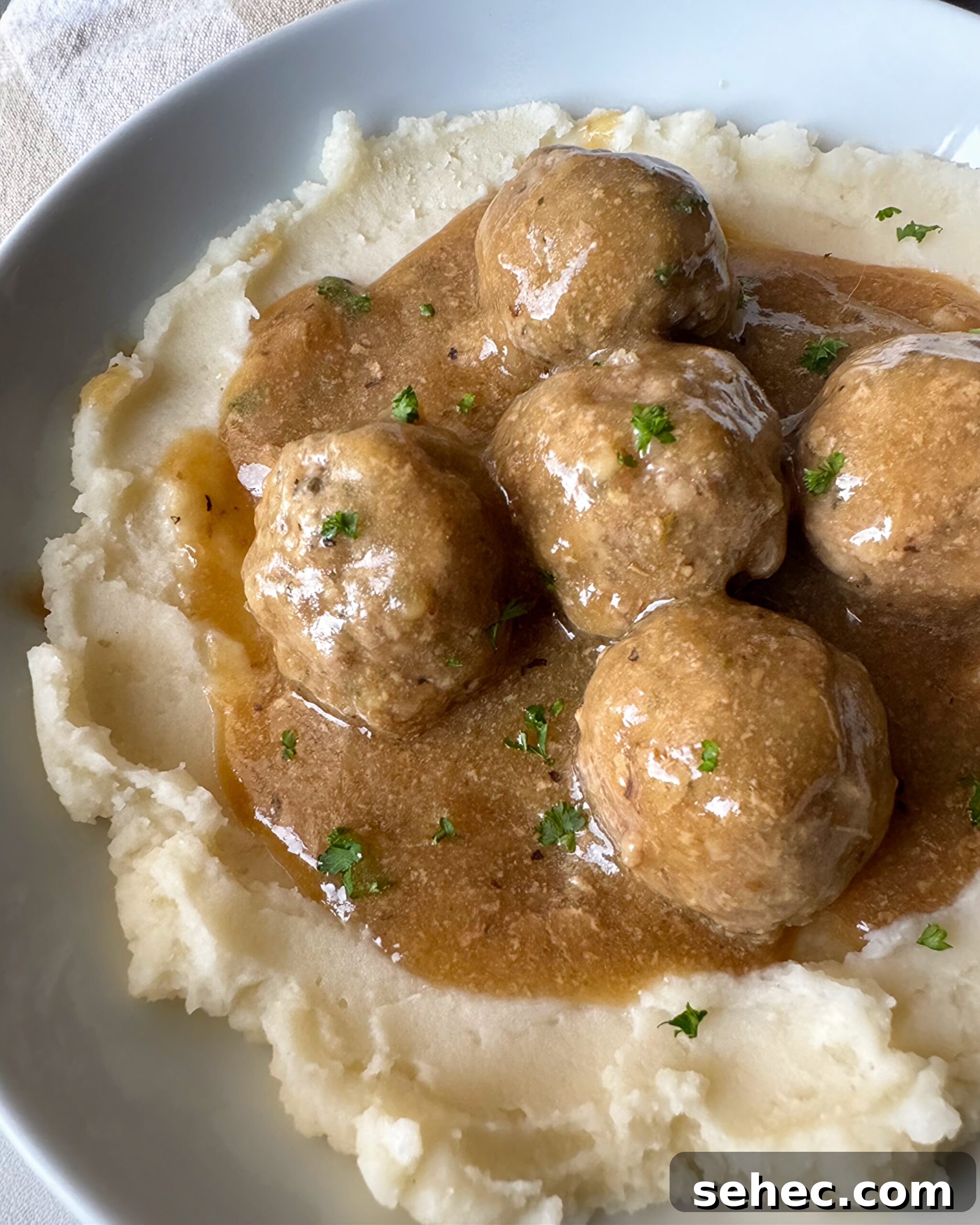 Crockpot Meatballs with Rich Brown Gravy 6 overhead shot of cooked meatballs and gravy served over mashed potatoes