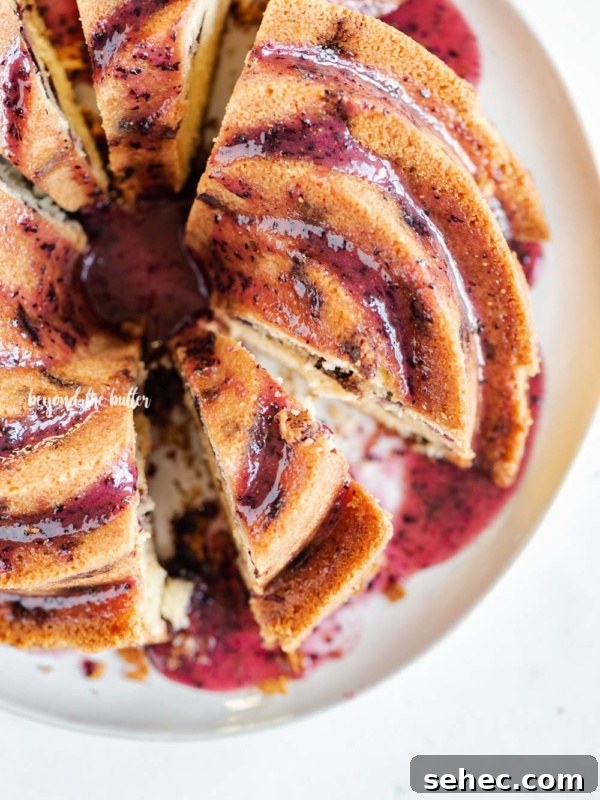Moist Marble Bundt Cake Recipe 18 Overhead image of sliced blueberry bundt cake with blueberry glaze drizzled over the top.