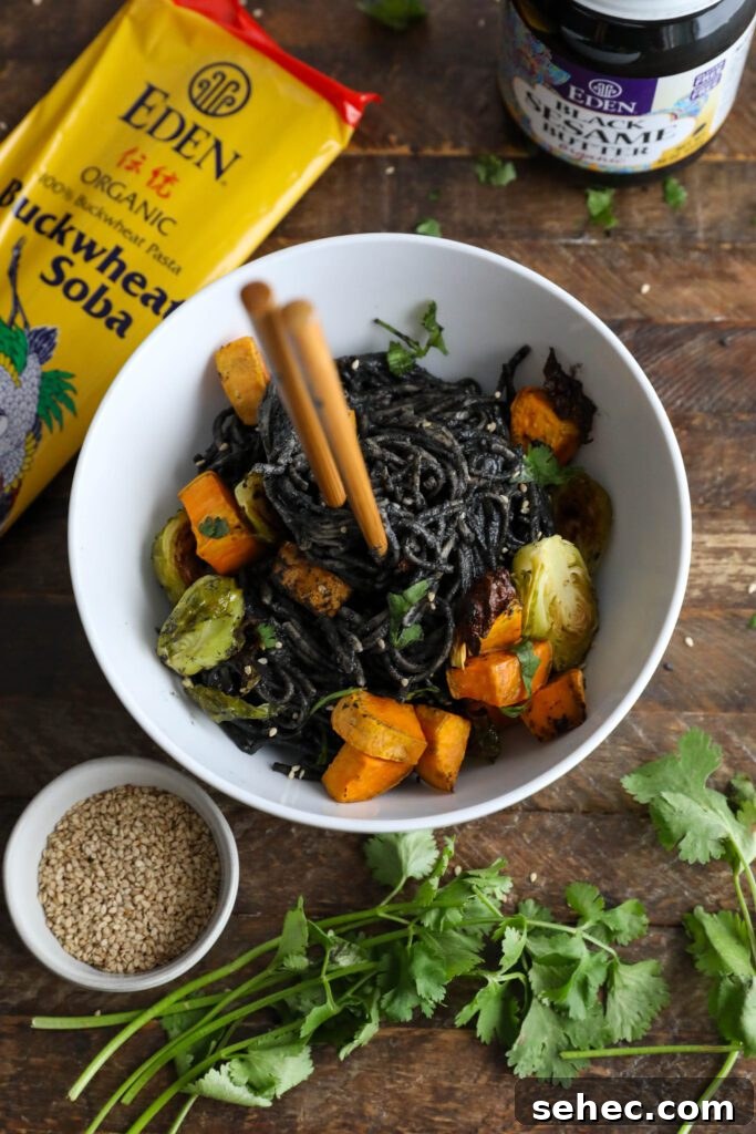 Black Sesame Noodle Bowl with Crunchy Vegetables 11 Black Sesame Noodle Bowl served in bowl topped with cilantro and sesame seeds