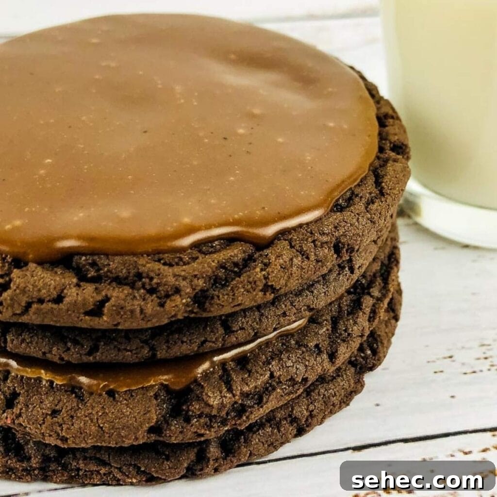 White Chocolate Peanut Butter Cookies Recipe 3 A stack of Texas sheet cake cookies next to a glass of milk.