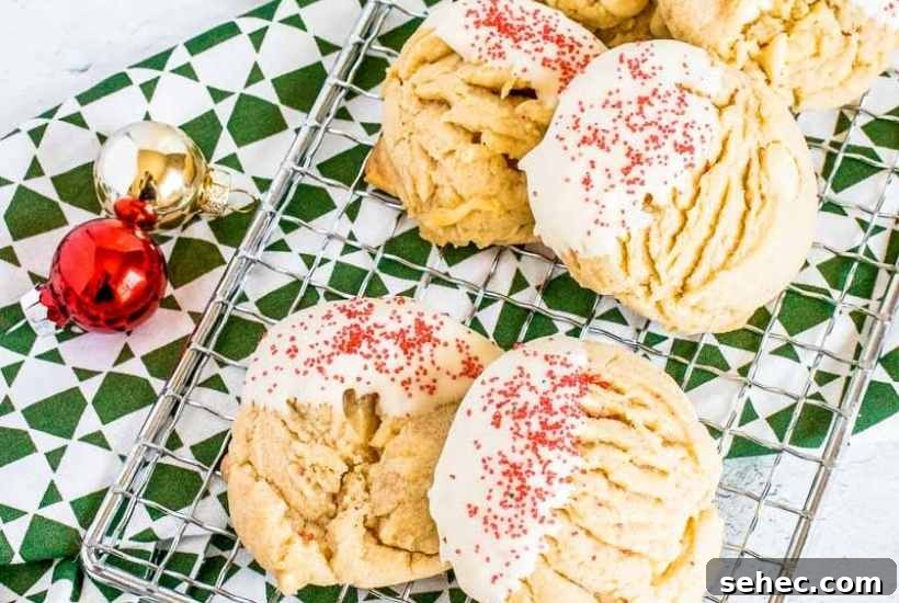 White Chocolate Peanut Butter Cookies Recipe 9 Peanut butter white chocolate chip cookies on a wire rack next to Christmas ornaments.