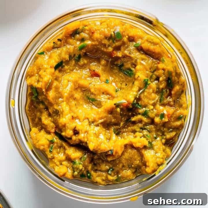 Indian Butter Chicken Recipe with Creamy Tomato Sauce 7 Homemade Thai yellow curry paste in a jar on a white table.