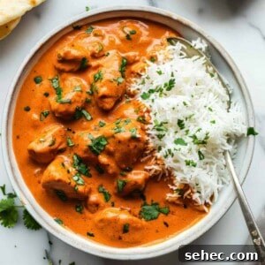 Indian Butter Chicken Recipe with Creamy Tomato Sauce 10 Indian butter chicken with rice in a white bowl.