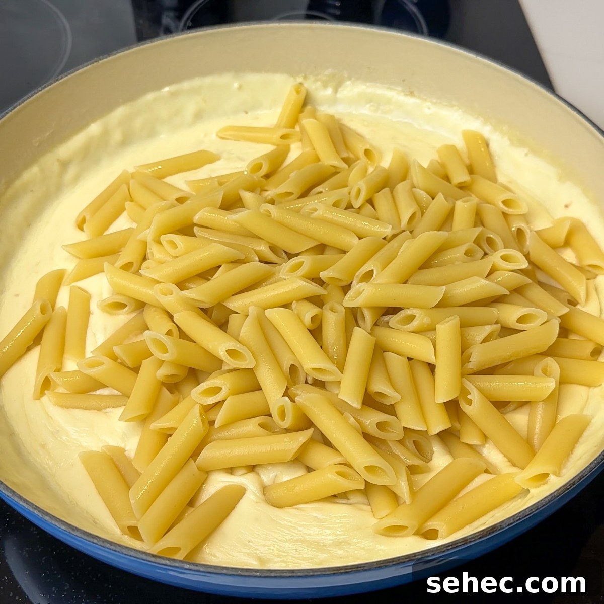Creamy Garlic Penne Pasta Recipe 6 Add al dente penne pasta and mix well