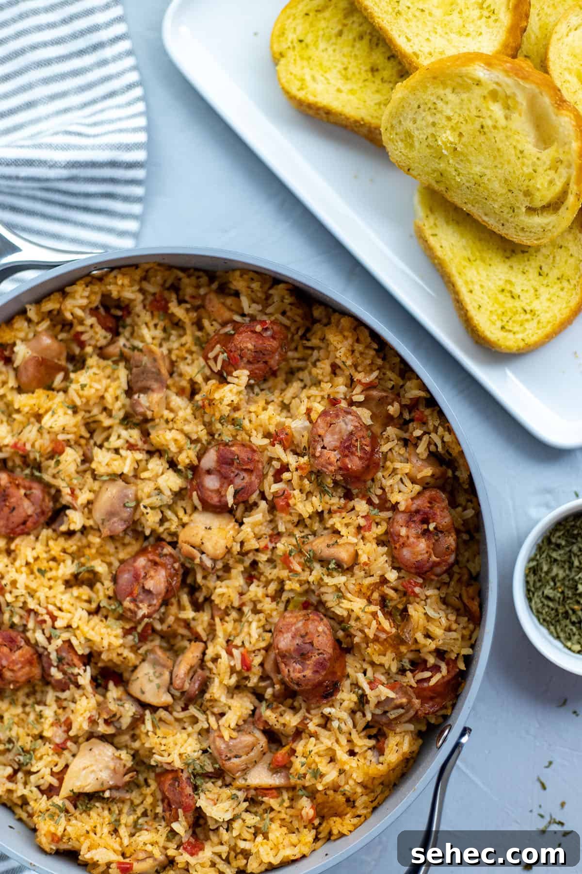 Cajun Chicken and Sausage Jambalaya Recipe 5 Cooked Chicken and Sausage Jambalaya in pan with toasted french bread on the side.