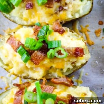 Close up of baked potatoes with bacon and green onions