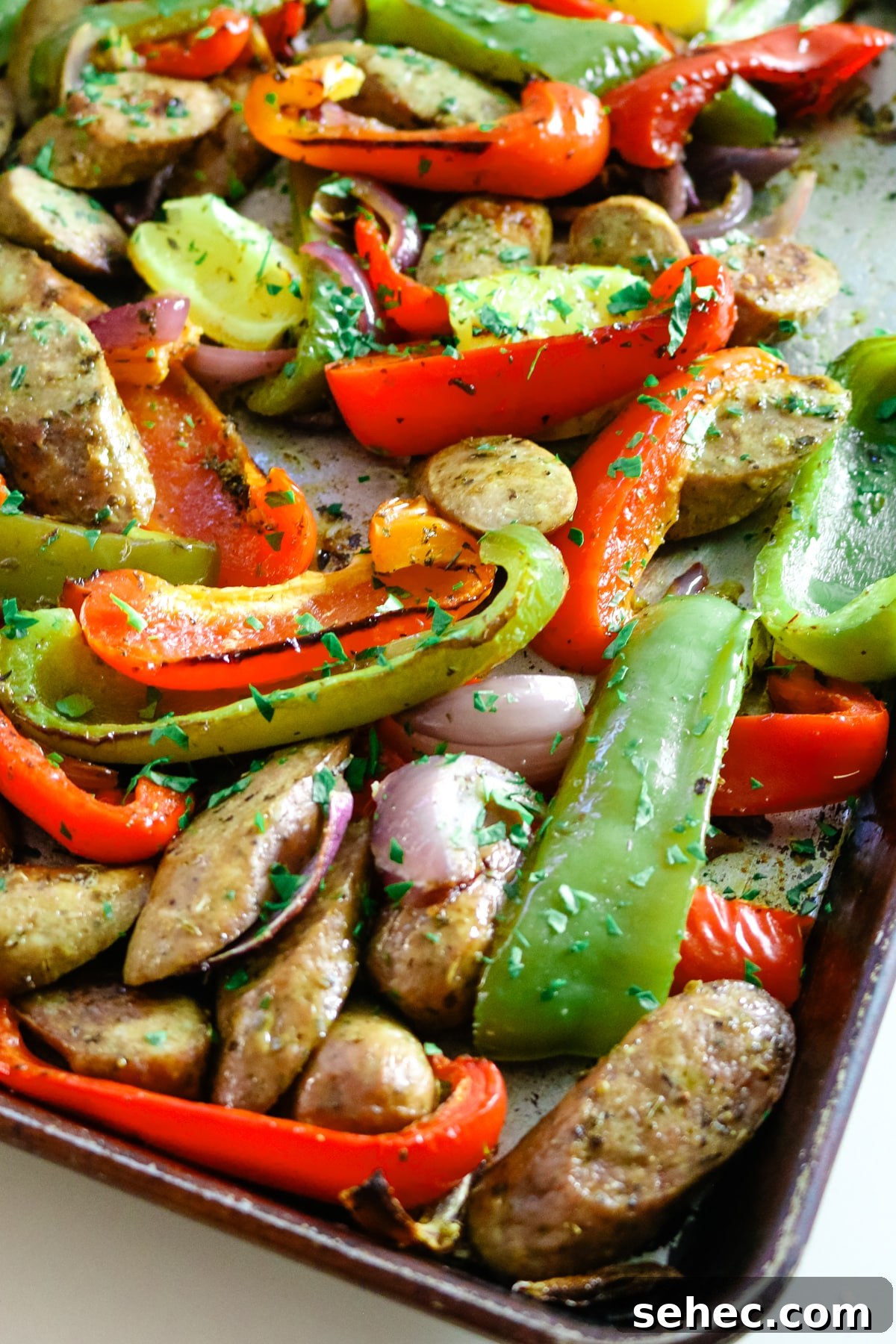 Oven Baked Sausage and Peppers Recipe 5 Sausage and peppers on a baking sheet.