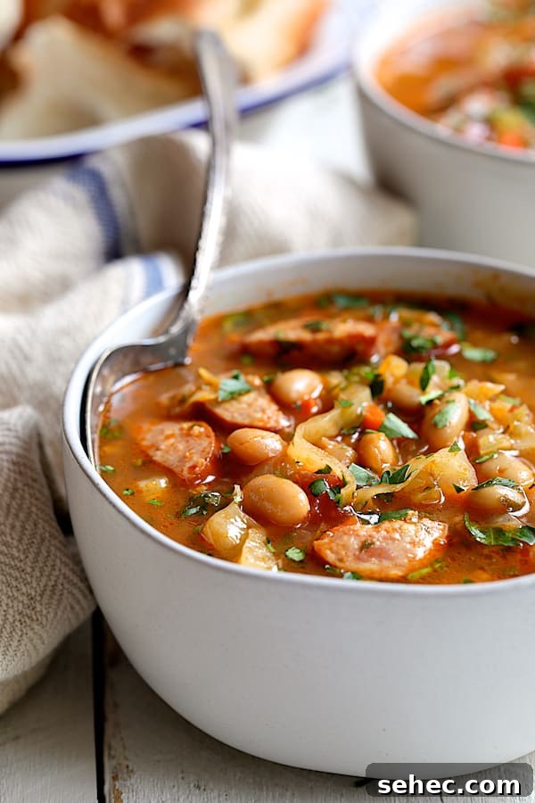 Farmhouse Kielbasa Cabbage Soup with Cannellini Beans 6 Close-up photo of one serving of Farmhouse Cabbage Soup with Cannellini Beans and Kielbasa.
