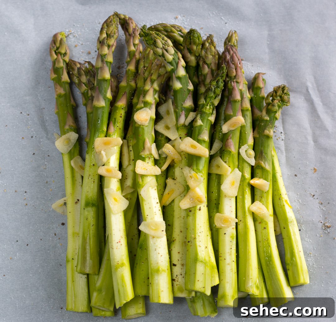 Spring Asparagus Pasta Baked in Parchment 5 Peeled asparagus topped with thin sliced garlic on parchment paper