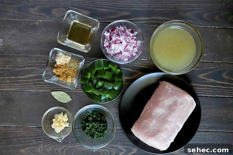 Slow Cooker Pork Tacos for Taco Tuesday 7 Horizontal image of assorted chopped fresh ingredients and spices in bowls next to a plate of raw meat.