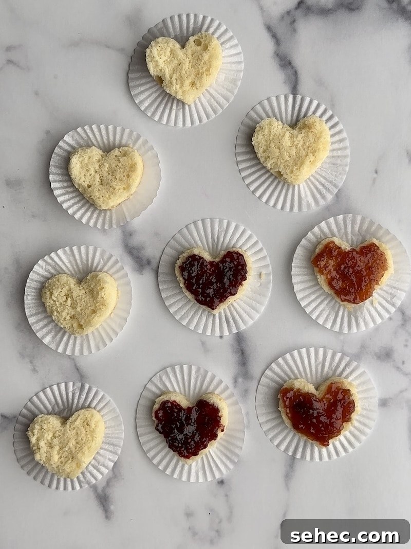 Mini Heart Cakes Made Two Ways 6 The bottom layer of several small heart cakes with cake filling on them.
