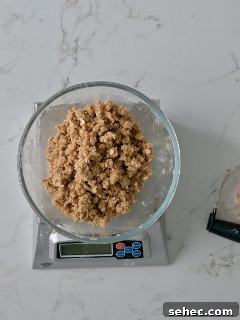 Moist Applesauce Crumb Cake with Cinnamon Streusel 15 Moist Crumbs for the applesauce cake crumb topping in a bowl on a scale.