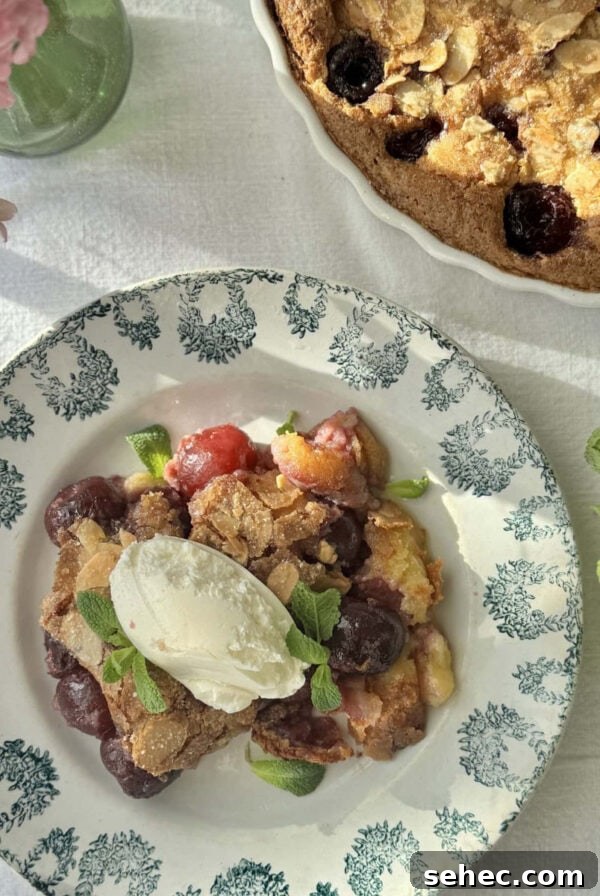 Nutella Salted Caramel Brioche Bread Pudding 11 clafoutis aux cerises in a bowl with mascarpone on top and more fresh cherries.