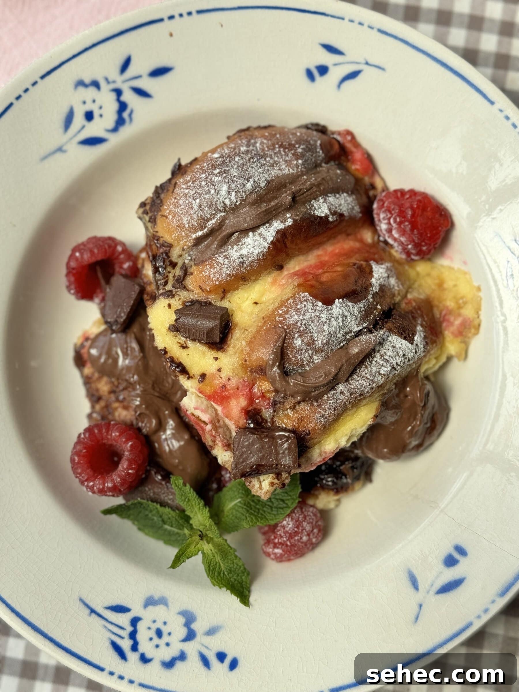 Nutella Salted Caramel Brioche Bread Pudding 3 a portion of bread and brioche pudding on plate with blue flowers