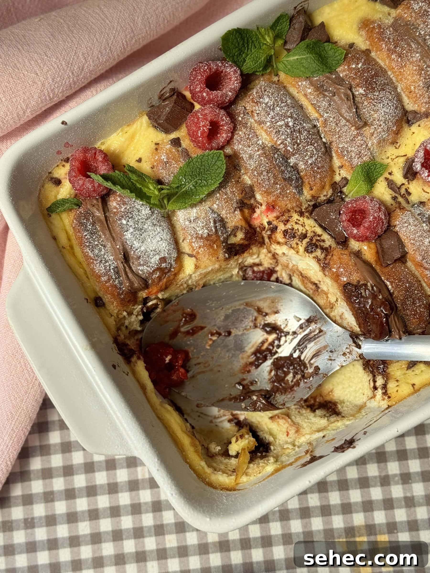 Nutella Salted Caramel Brioche Bread Pudding 10 spoon out of brioche pudding in the tin