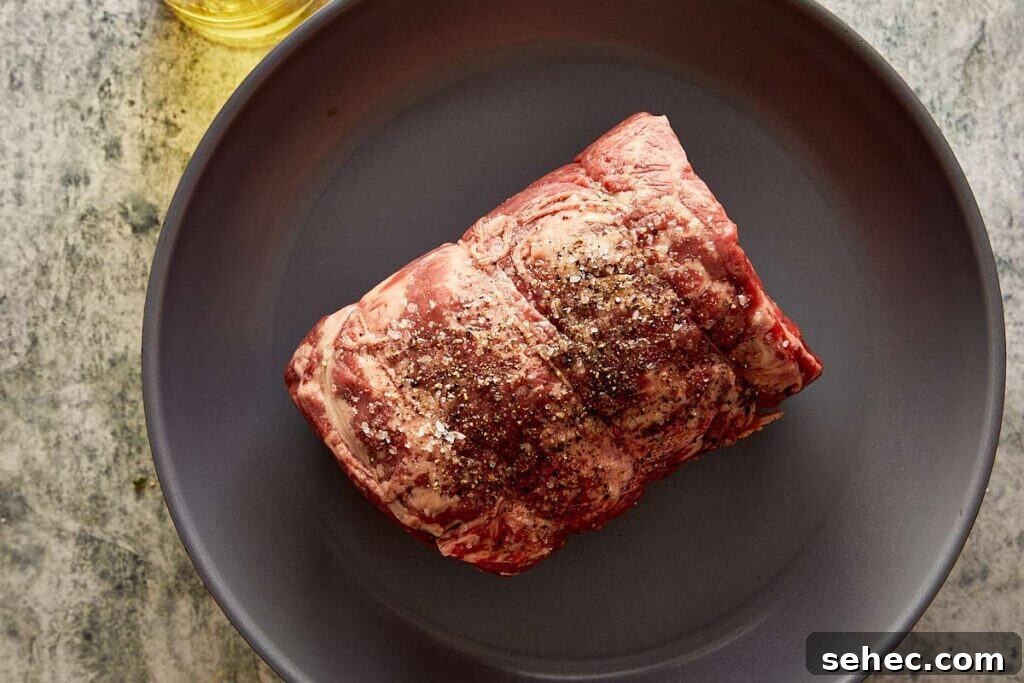 Truffle Beef Wellington Recipe with Red Wine Sauce 5 a raw beef log on a plate