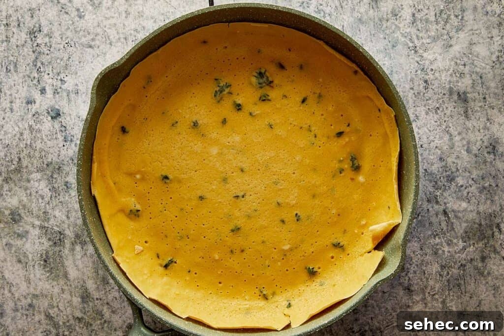 Truffle Beef Wellington Recipe with Red Wine Sauce 8 a thyme crepe in a round baking pan raw