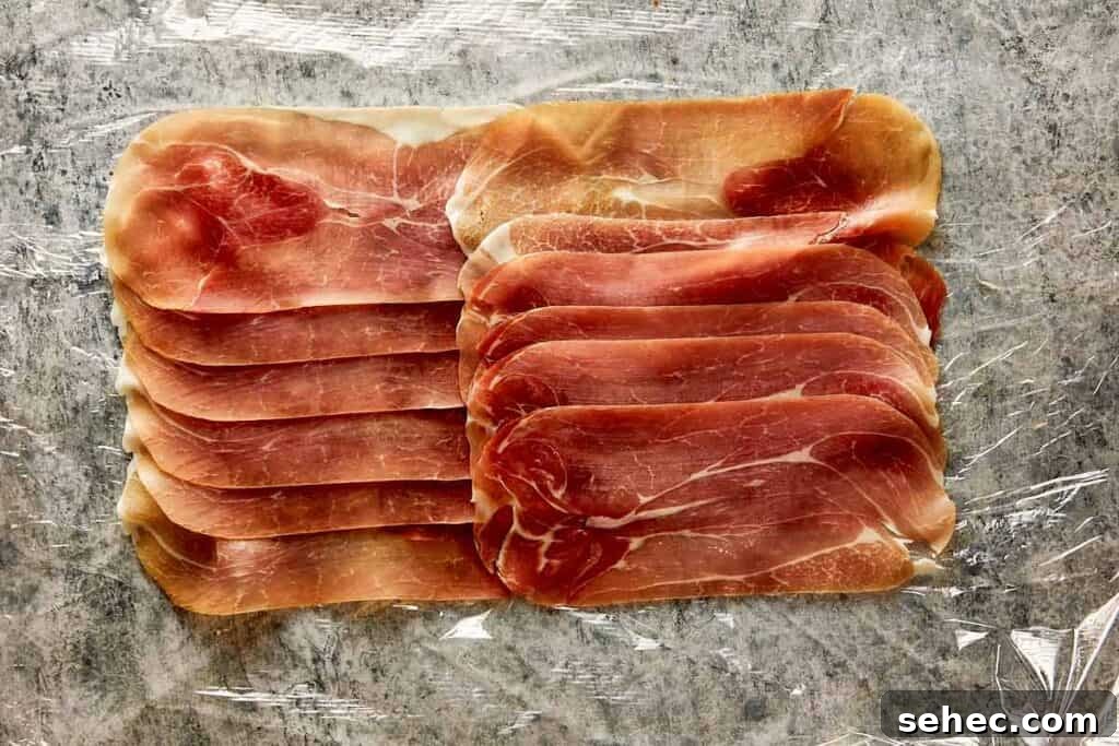 Truffle Beef Wellington Recipe with Red Wine Sauce 9 prosciutto layed out in layers ready to wrap in the meat