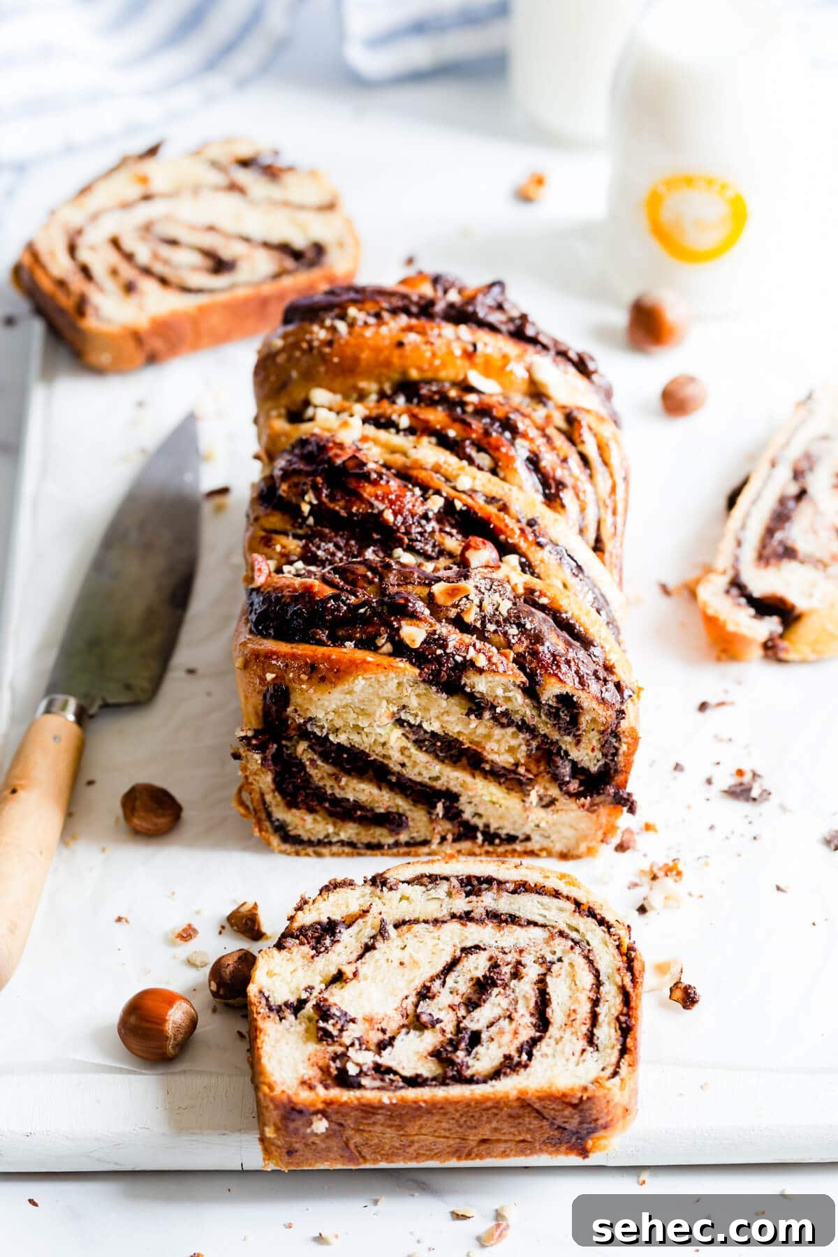 Nutella Babka Recipe: Chocolate-Hazelnut Swirl Loaf 2 45 degree angle view of loaf of babka with couple of slices cut off