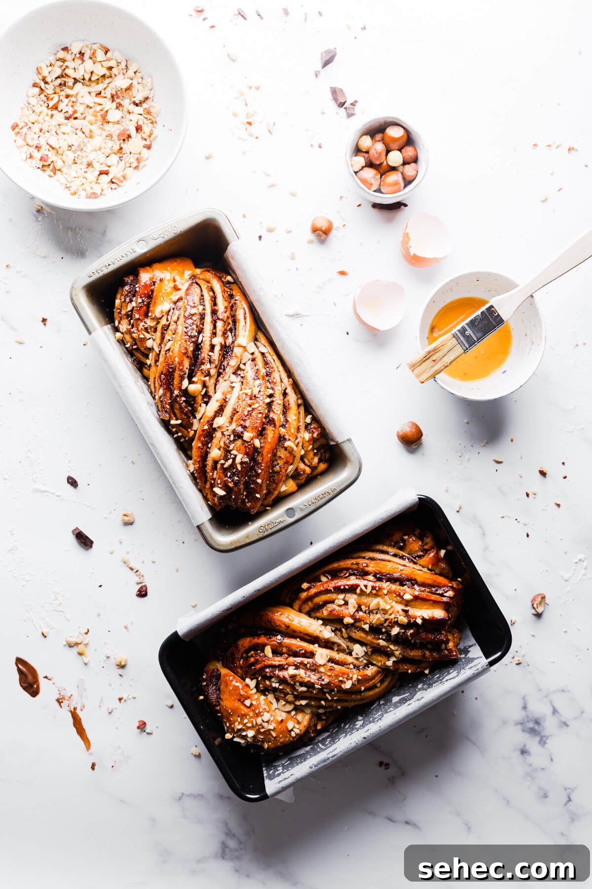 Nutella Babka Recipe: Chocolate-Hazelnut Swirl Loaf 3 overhead shot of two baked nutella babkas in loaf pans
