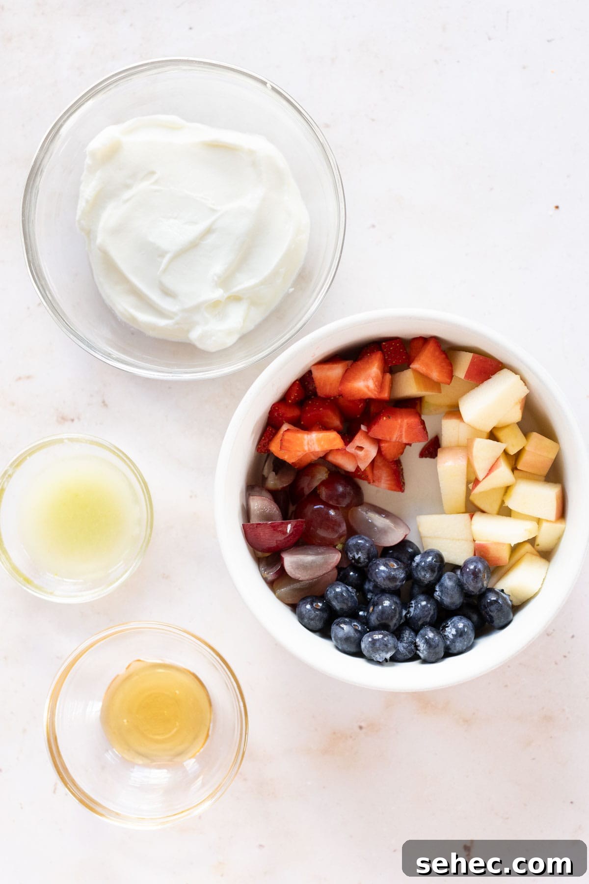 A bowl of fruit, yogurt, and other ingredients.