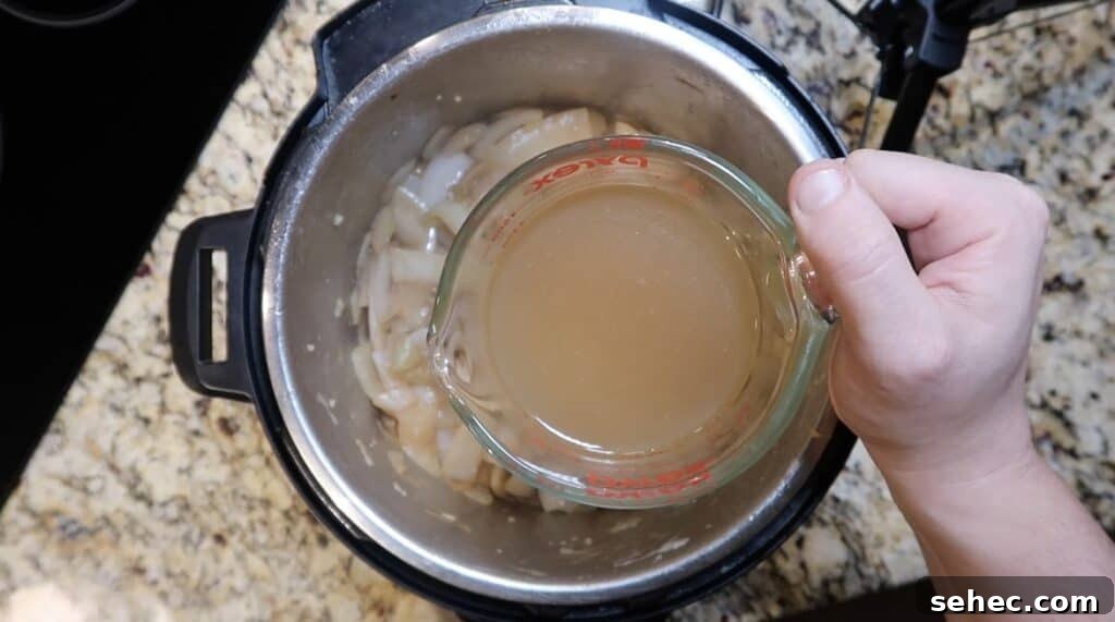 Adding broth to pot