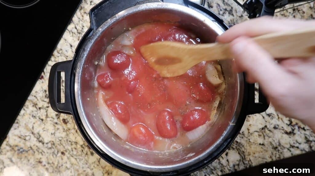 Smoothing out tomatoes in pot.