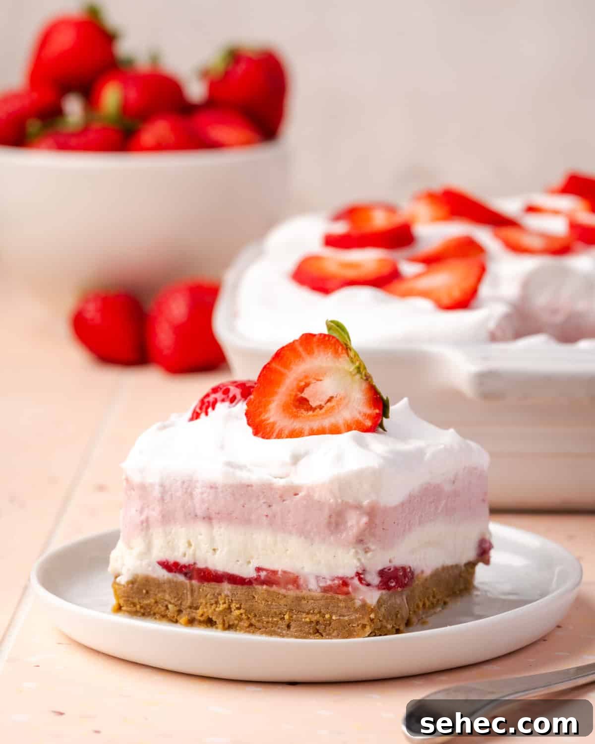 No Bake Strawberry Cheesecake Cups 2 A slice of no bake strawberry delight served on a white plate.