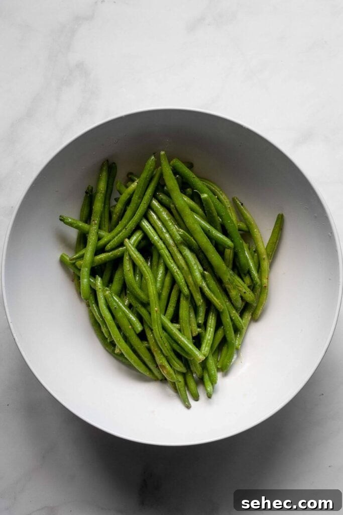 Crispy Air Fryer Green Beans: 4 Flavorful Recipes 5 green beans seasoned in salt, pepper, and olive oil