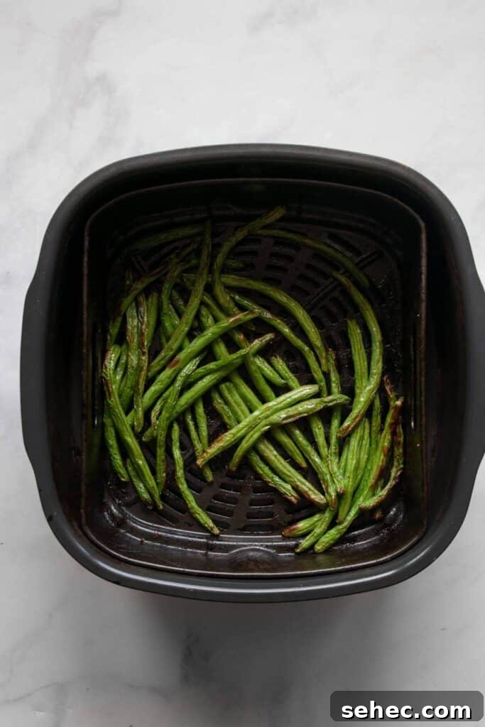 Crispy Air Fryer Green Beans: 4 Flavorful Recipes 7 crispy green beans in air fryer basket
