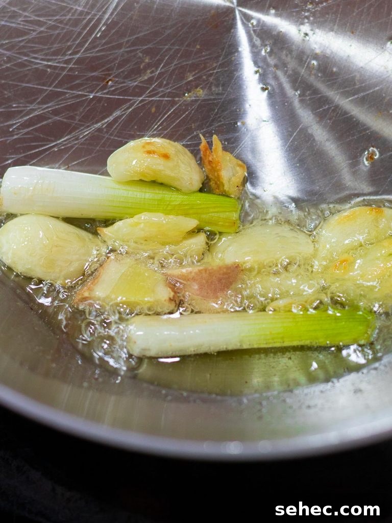 scallions, ginger, and garlic frying in oil