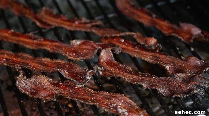 Crispy Smoked Bacon cooking on a smoker