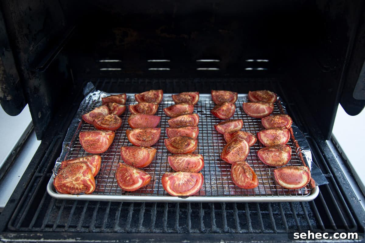 A sheet pan of tomatoes on the grill