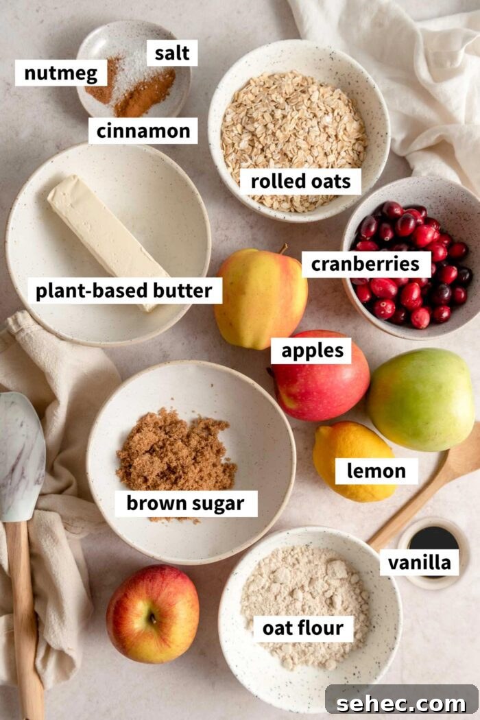 All the ingredients for apple cranberry crisp recipe. Each ingredient is labelled with text.