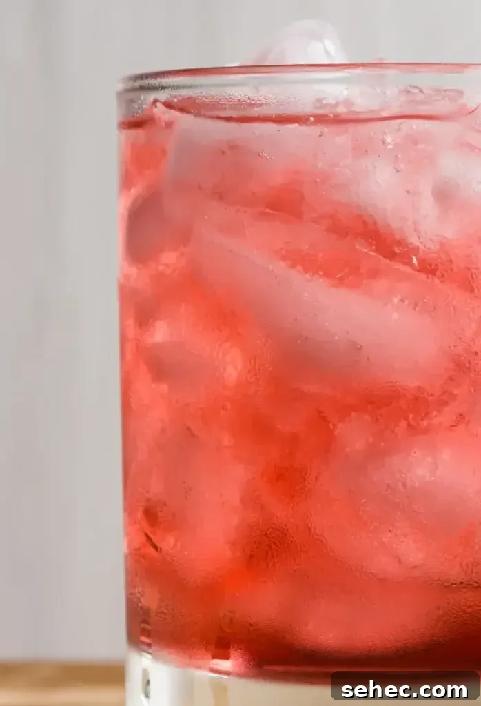 Blackberry Margarita Smash Cocktail Recipe 4 Pouring a Blackberry Margarita Smash over ice
