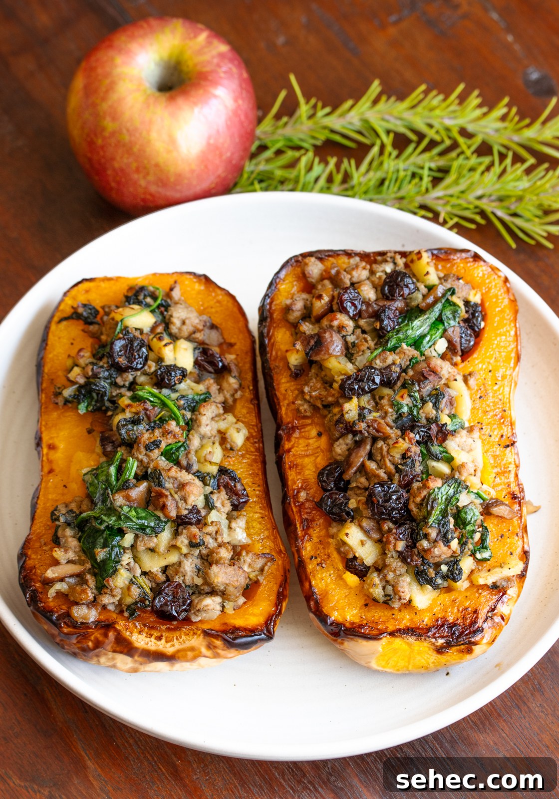 Sausage-Stuffed Butternut Squash with Sage and Parmesan 8 ready to be enjoyed on a white serving plate