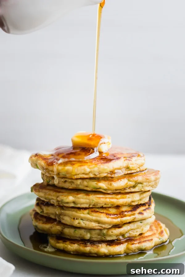 Fluffy Zucchini Bread Pancakes Recipe 3 A stack of zucchini bread pancakes.