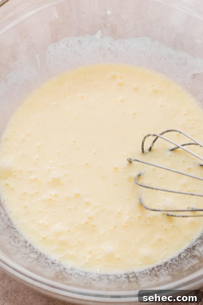 Fluffy Zucchini Bread Pancakes Recipe 4 A bowl of wet ingredients.