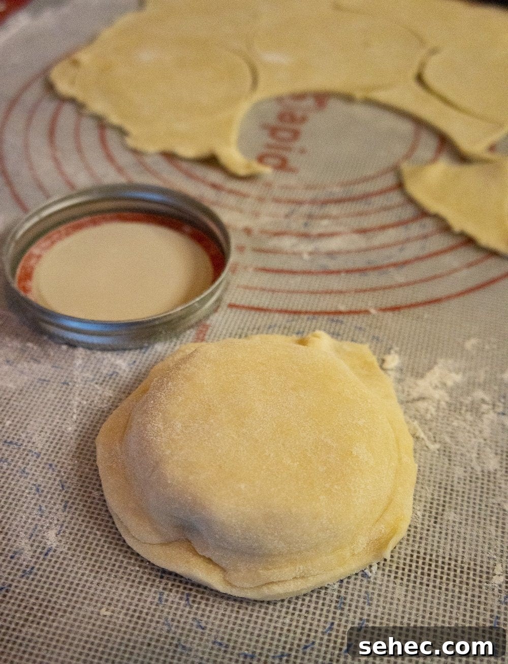 mini peach pie being formed